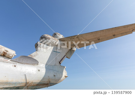 Close-up of abandoned ekranoplan wing and tail against clear blue sky 139587900