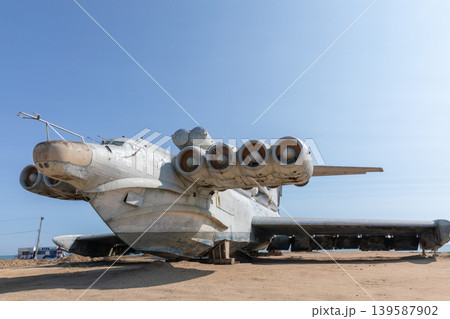 Abandoned Soviet ekranoplan on sandy shore under clear blue sky, Dagestan Abandoned Soviet ekranoplan on sandy shore under clear blue sky, Dagestan 139587902