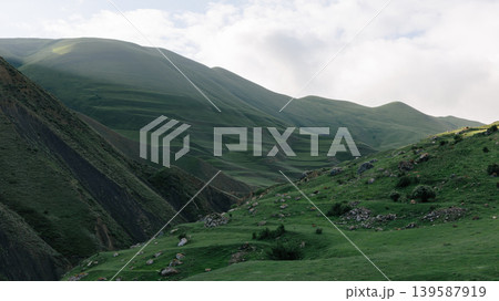 Mountain road to Mount Shalbuzdag through green highlands in Dagestan Mountain road to Mount Shalbuzdag through green highlands in Dagestan 139587919