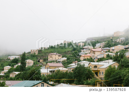 Misty hillside village houses in Kubachi with green terraces, Dagestan mountains Misty hillside village houses in Kubachi with green terraces, Dagestan mountains 139587928