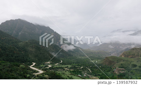 Misty mountain valley with winding road in Dagestan, Caucasus landscape view Misty mountain valley with winding road in Dagestan, Caucasus landscape view 139587932
