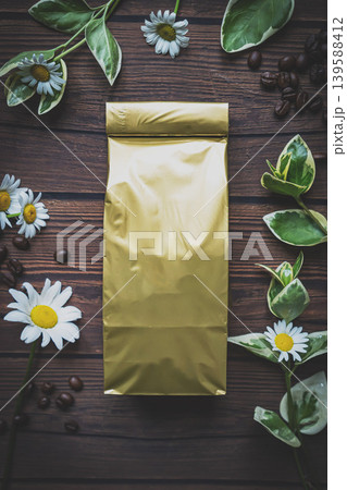 Mock-up craft paper pouch bag top view over white wooden table lying at coffee beans Mock-up craft paper pouch bag top view over white wooden table lying at coffee beans 139588412