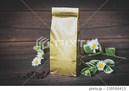 Mock-up craft paper pouch bag top view over white wooden table lying at coffee beans Mock-up craft paper pouch bag top view over white wooden table lying at coffee beans 139588413
