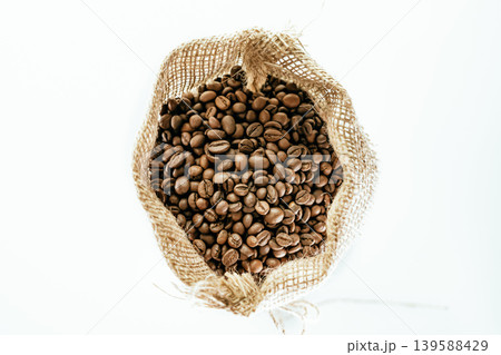 Roasted coffee beans in sack bag isolated on white background. 139588429