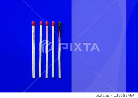 Success, defeat, achievement. The concept of happiness. Matches on a yellow background. Burnt dark match among normal matches. Burning match fire to its neighbors, a metaphor for ideas and inspiration Success, defeat, achievement. The concept of happiness. Matches on a yellow background. Burnt dark match among normal matches. Burning match fire to its neighbors, a metaphor for ideas and inspiration 139588464