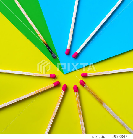 Success, defeat, achievement. The concept of happiness. Matches on a yellow background. Burnt dark match among normal matches. Burning match fire to its neighbors, a metaphor for ideas and inspiration Success, defeat, achievement. The concept of happiness. Matches on a yellow background. Burnt dark match among normal matches. Burning match fire to its neighbors, a metaphor for ideas and inspiration 139588473