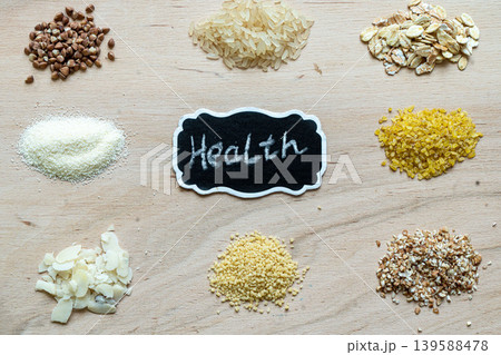 Assorted cereal grain porridge seeds set on a wooden background: buckwheat, rice, semolina, wheat, couscous, oatmeal Assorted cereal grain porridge seeds set on a wooden background: buckwheat, rice, semolina, wheat, couscous, oatmeal 139588478
