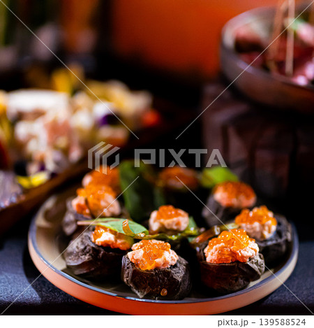 Pumpernickel bread sandwich snack with cured smoked salmon and fresh avocado served as close-up on a wooden cutting board Pumpernickel bread sandwich snack with cured smoked salmon and fresh avocado served as close-up on a wooden cutting board 139588524