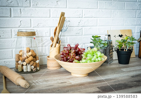 A modern kitchen design with delicious pastries and fresh grapes elegantly displayed kitchen A modern kitchen design with delicious pastries and fresh grapes elegantly displayed kitchen 139588583