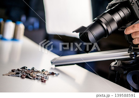 Making video of Metal zipper slide isolated on white. Assortment of zipper slides. Clothing element. Making video of Metal zipper slide isolated on white. Assortment of zipper slides. Clothing element. 139588591