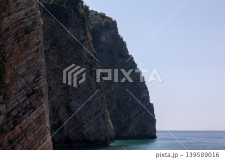 Rocky sea cliffs on Sveti Nikola Island near Budva, Montenegro coastline 139589016