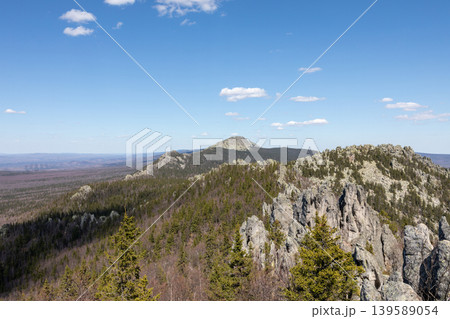 Taganay National Park mountain ridge with rocky cliffs and taiga forest panorama 139589054