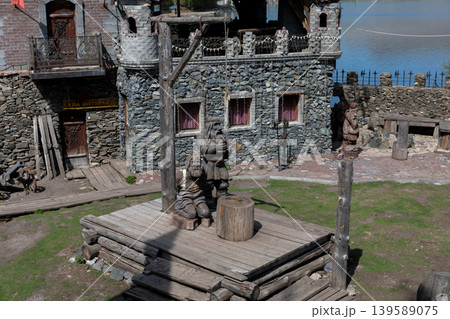 Rustic wooden sculptures and stone buildings at Sonkina Laguna, Satka park 139589075