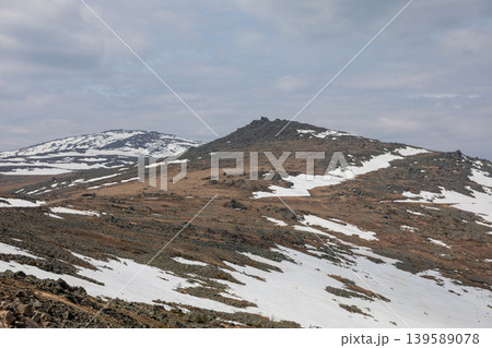 Konzhakovsky Kamen mountain tundra landscape with melting snow, Ural Mountains Konzhakovsky Kamen mountain tundra landscape with melting snow, Ural Mountains 139589078