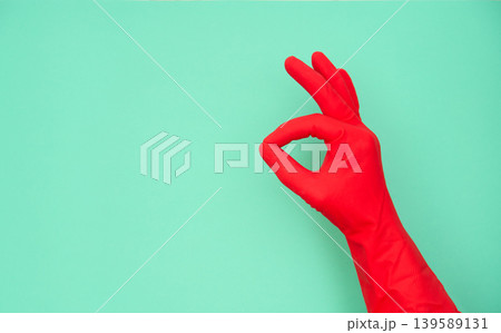 Hand in red rubber glove making okay sign Hand in red rubber glove making okay sign 139589131