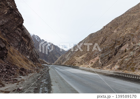 Mountain road through rocky gorge at Too Ashuu Pass in Kyrgyzstan, Central Asia Mountain road through rocky gorge at Too Ashuu Pass in Kyrgyzstan, Central Asia 139589170