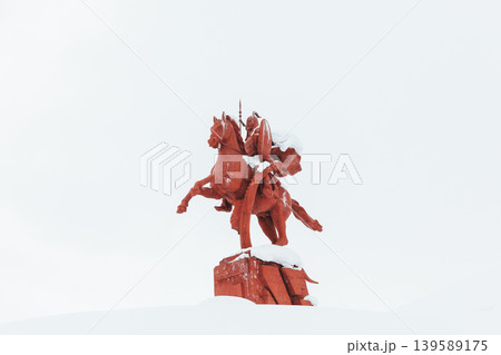 Red Manas equestrian monument covered with snow at Ala-Bel Pass, Kyrgyzstan 139589175