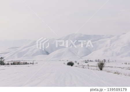 Snowy valley and mountain range landscape near Toktogul in Kyrgyzstan 139589179