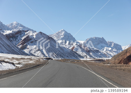 Pamir Highway mountain road through snowy peaks and valleys in Kyrgyzstan Pamir Highway mountain road through snowy peaks and valleys in Kyrgyzstan 139589194