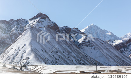 Snowy mountain landscape along Pamir Highway in Kyrgyzstan on sunny winter day Snowy mountain landscape along Pamir Highway in Kyrgyzstan on sunny winter day 139589195