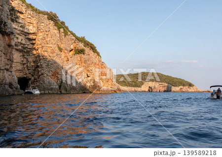 Rocky sea cave and limestone cliffs near Budva viewed from a small boat Rocky sea cave and limestone cliffs near Budva viewed from a small boat 139589218