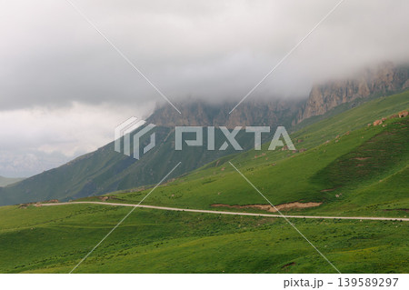 Misty mountain landscape with winding road near Aktoprak village, Caucasus Misty mountain landscape with winding road near Aktoprak village, Caucasus 139589297