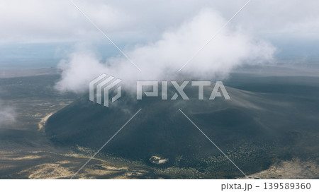 Aerial view of Tolbachinsky Dol volcanic cone with clouds, Kamchatka Peninsula Aerial view of Tolbachinsky Dol volcanic cone with clouds, Kamchatka Peninsula 139589360