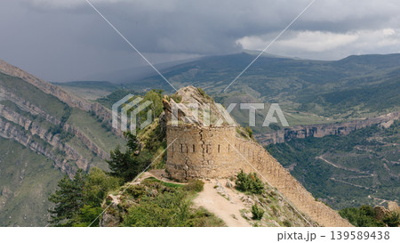 Gunib fortress stone wall ruins on mountain ridge with stormy sky, Gunib village Gunib fortress stone wall ruins on mountain ridge with stormy sky, Gunib village 139589438