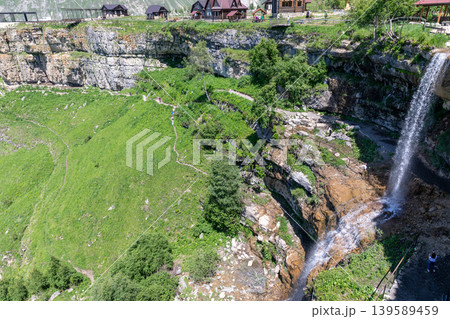 Matlas waterfalls cascading into a rocky canyon with mountain village viewpoint Matlas waterfalls cascading into a rocky canyon with mountain village viewpoint 139589459