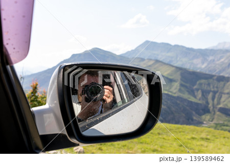 Photographer in car side mirror with Caucasus mountains view, Dagestan road trip Photographer in car side mirror with Caucasus mountains view, Dagestan road trip 139589462