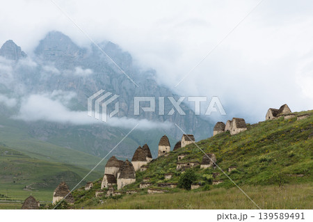 Dargavs City of the Dead necropolis tombs on mountain slope in Caucasus Dargavs City of the Dead necropolis tombs on mountain slope in Caucasus 139589491