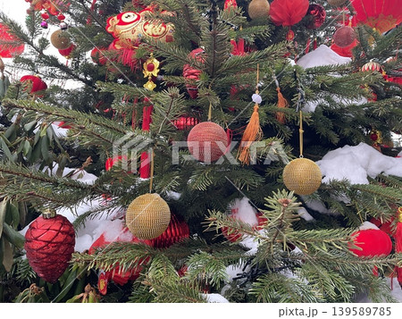 Christmas tree decorated with Chinese ornaments in snow for festive holiday celebration background Christmas tree decorated with Chinese ornaments in snow for festive holiday celebration background 139589785