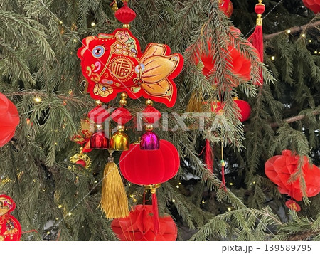 Chinese New Year decorations hanging on tree with vibrant red ornaments and gold accents Chinese New Year decorations hanging on tree with vibrant red ornaments and gold accents 139589795