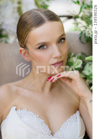 Bride posing in wedding dress with pearls Bride posing in wedding dress with pearls 139590326