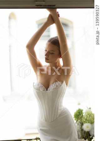 Woman posing in elegant corset wedding dress Woman posing in elegant corset wedding dress 139590327
