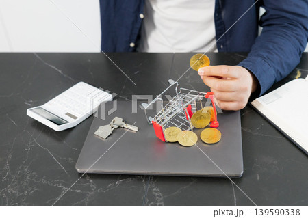 Man calculating cryptocurrency investment for real estate Man calculating cryptocurrency investment for real estate 139590338