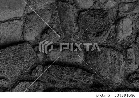 Large stones background old coarse cobblestones texture concrete surface black dark solid structure rough, close-up 139591086