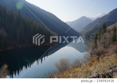 Kolsai Lake in Kazakhstan with forest and mountains reflecting in water 139591416