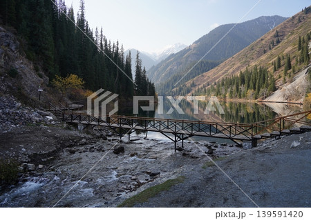 Kolsai Lake in Kazakhstan with forest and mountains reflecting in water Kolsai Lake in Kazakhstan with forest and mountains reflecting in water 139591420