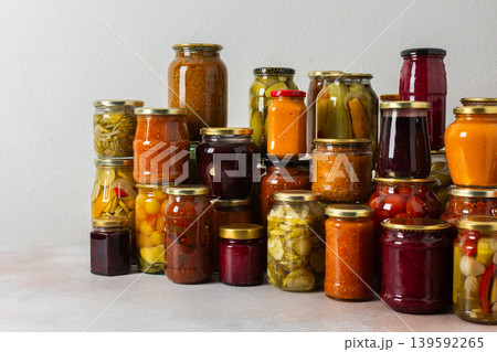 Canning is a common activity in the kitchen as jars filled with vegetables and fruits line the counter. This practice helps in preserving food for winter use and has a long tradition Canning is a common activity in the kitchen as jars filled with vegetables and fruits line the counter. This practice helps in preserving food for winter use and has a long tradition 139592265