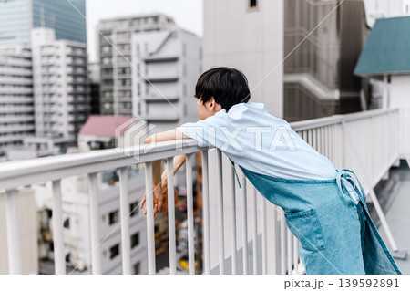 屋上で背を向けて街を眺める男性 屋上で背を向けて街を眺める男性 139592891