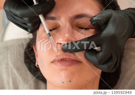 Cosmetologist Performing Facial Injection Procedure Close Up Cosmetologist Performing Facial Injection Procedure Close Up 139592949