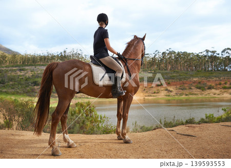 Equestrian, woman and horse in nature for ride on adventure and journey in countryside. Ranch, animal and rider outdoor with hobby, sport or pet on farm trail with girl in summer at river with peace Equestrian, woman and horse in nature for ride on adventure and journey in countryside. Ranch, animal and rider outdoor with hobby, sport or pet on farm trail with girl in summer at river with peace 139593553