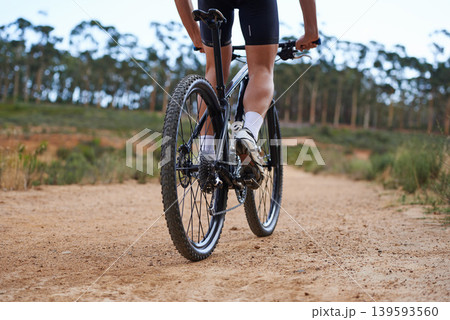 Person, legs and mountain bike for cycling adventure on nature path for healthy challenge, performance or extreme sport. Athlete, clip on cycle shoes and off road dirt terrain, speed or back view Person, legs and mountain bike for cycling adventure on nature path for healthy challenge, performance or extreme sport. Athlete, clip on cycle shoes and off road dirt terrain, speed or back view 139593560