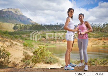 Young women, portrait or fitness in forest to exercise, outdoor or water bottle by blue sky. Diversity, teenagers and happy face for workout in gym clothes and training in countryside for wellness Young women, portrait or fitness in forest to exercise, outdoor or water bottle by blue sky. Diversity, teenagers and happy face for workout in gym clothes and training in countryside for wellness 139593615