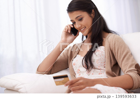 Happy woman, phone call and credit card on sofa for online shopping, payment or banking at home. Female person talking on mobile smartphone with smile for ecommerce, debit or conversation on account Happy woman, phone call and credit card on sofa for online shopping, payment or banking at home. Female person talking on mobile smartphone with smile for ecommerce, debit or conversation on account 139593633