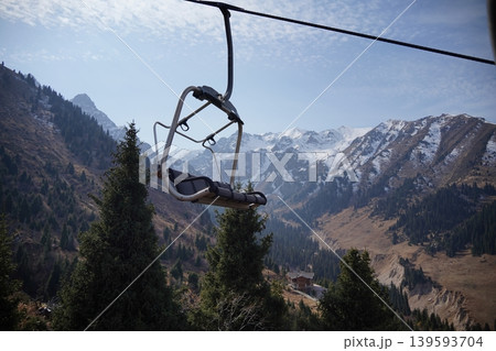 Mountain chairlift transport system for hikers and skiers at Shymbulak Ski Resort. Mountain chairlift transport system for hikers and skiers at Shymbulak Ski Resort. 139593704