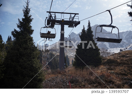Mountain chairlift transport system for hikers and skiers at Shymbulak Ski Resort. Mountain chairlift transport system for hikers and skiers at Shymbulak Ski Resort. 139593707