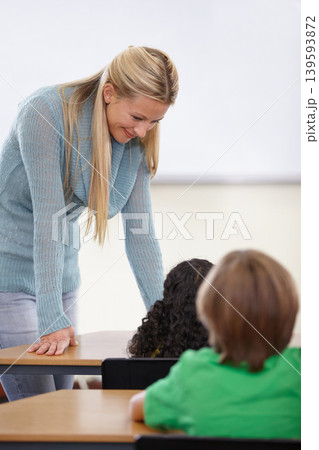 Teacher, children and students in classroom for education, learning and language development or support at desk. Happy woman with kids for teaching, helping with knowledge and questions at school Teacher, children and students in classroom for education, learning and language development or support at desk. Happy woman with kids for teaching, helping with knowledge and questions at school 139593872