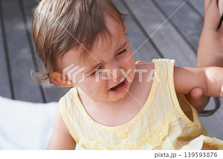 Baby, girl and unhappy or crying outside on porch, sad and upset for mistake or fail in childhood. Kid, toddler and frustration and distress for info, autism and overstimulation or adhd in outdoors 139593876